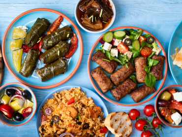 Various,Greek,Dishes,On,A,Blue,Wooden,Background